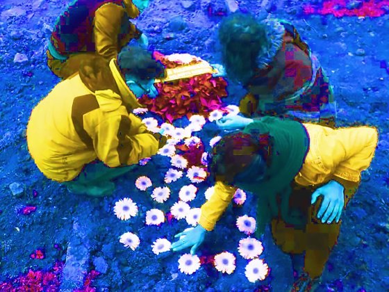 Image shows griefing persons at a grave