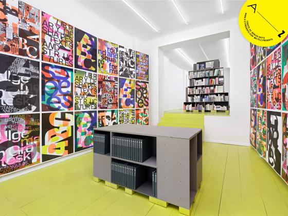 A—Z gallery space filled wall to wall and floor to ceiling with colourful typographic posters by Andrea Tinnes