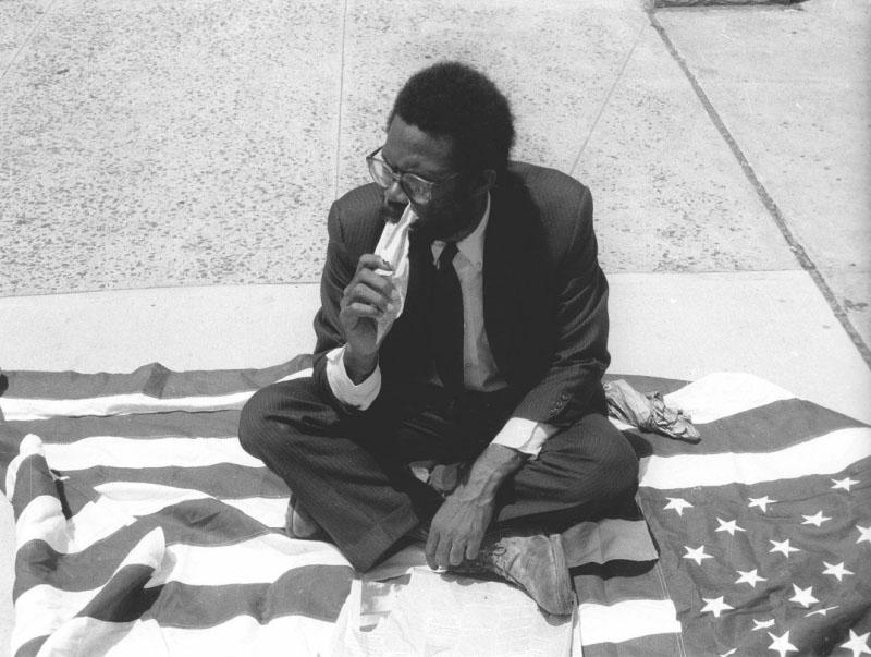 Pope.L "Eating the Wall Street Journal (Street Version)",1991