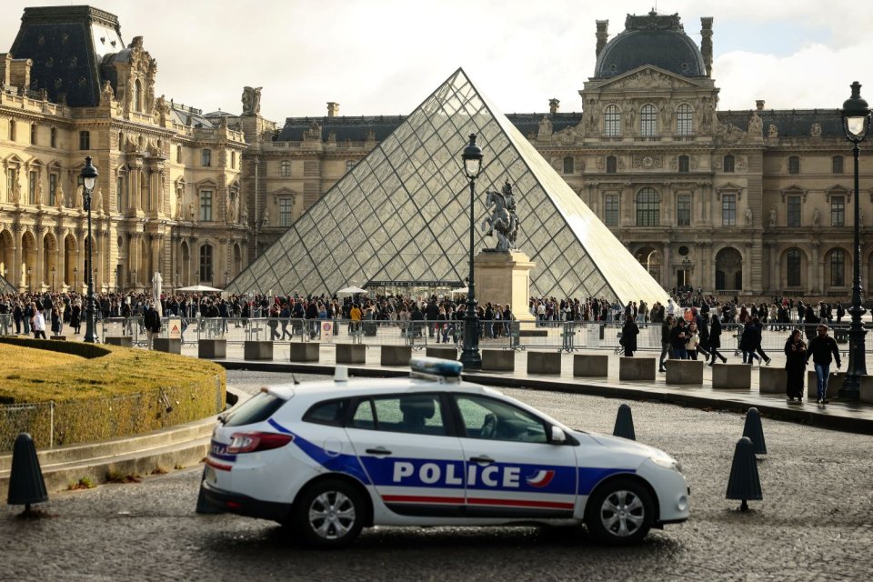 Foto: Louvre-Pyramide von I. M. Pei, Paris; Polizeiwagen vorn, Besucher in Warteschlange.